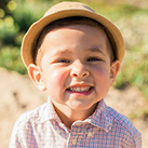 Smiling little boy with hat outdoors
