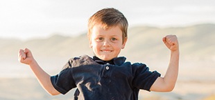 Little boy smiling at the beach