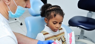 Girl listening to dentist in San Luis Obispo