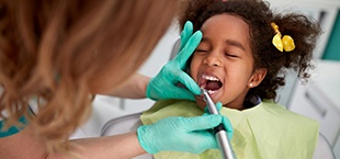 little girl having a cavity treated