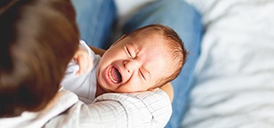 crying newborn that needs a frenectomy 