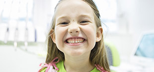 Smiling little girl in dental office