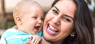 Laughing mother and baby