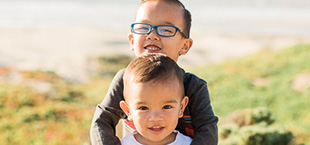 Two smiling kids at the beach