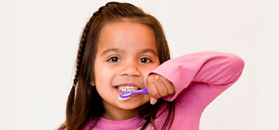 Young girl brushing teeth