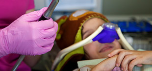 Child with nitrous oxide nose mask in place