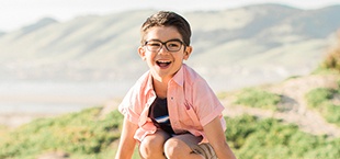 Laughing young boy at beach