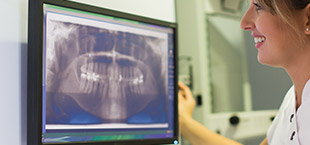 Woman looking at digital dental x-rays