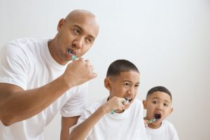 Family brushing their teeth together. 