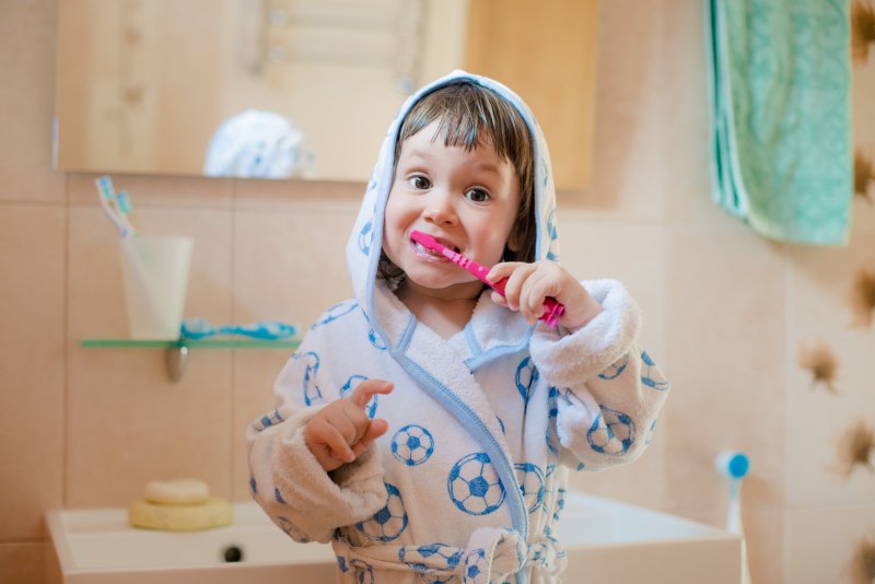 child brushing teeth in bathroom in San Luis Obispo