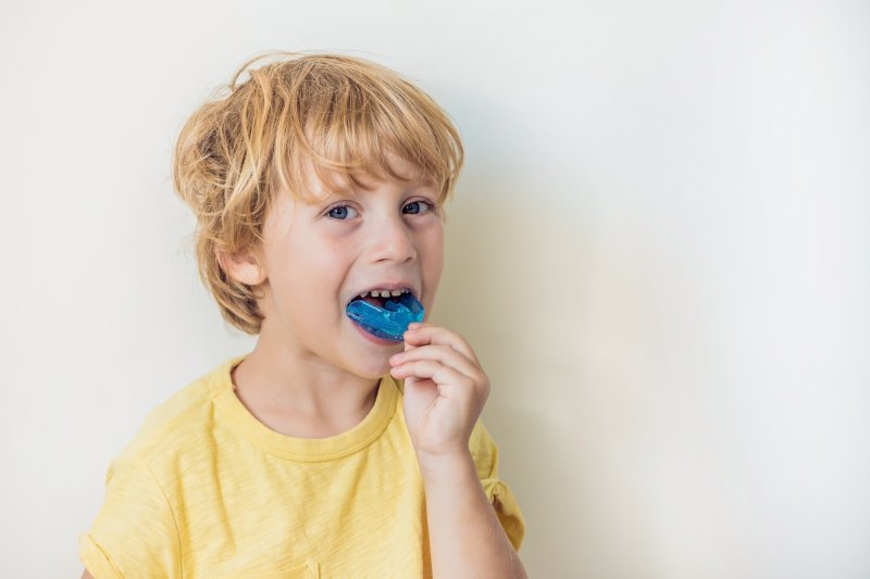 child with a customized mouthguard