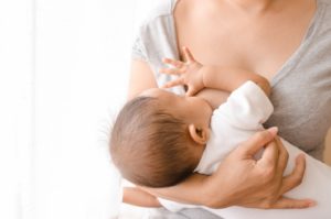 Mother nursing her baby after tongue tie treatment