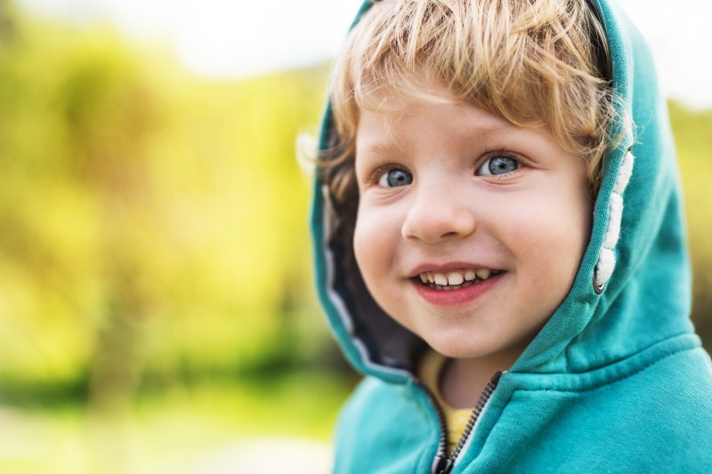 young boy smiling outside