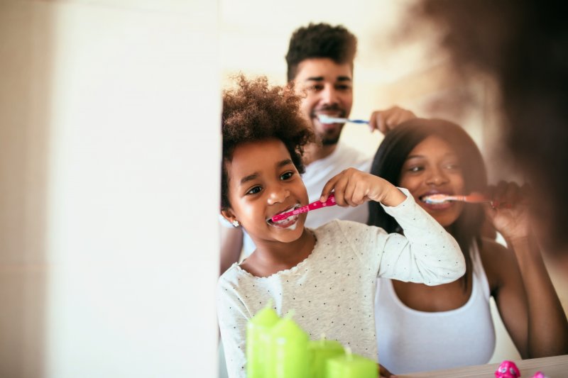 family brushing their teeth together